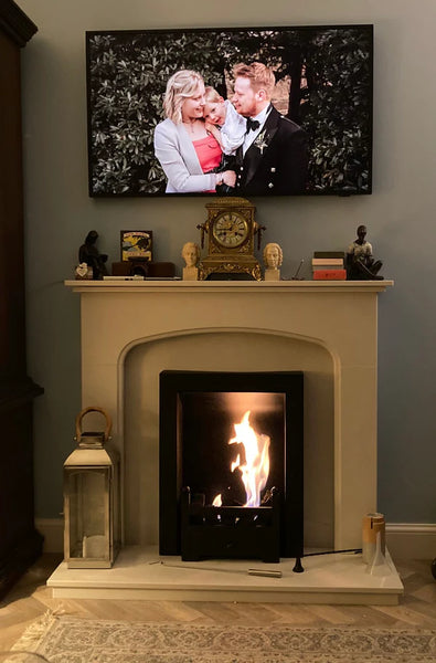 A Bioethanol metal framed Fireplace box Insert cassette to sit inside a fireplace opening and convert an old open, gas or electric fire inset into a working live fireplace with real flames and real heat but no chimney or flue is needed as it burns bio ethanol liquid / fuel and has a coal effect